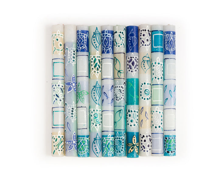 10 tapers in the designs of the Arniston candle collection. Fish, starfish, turtles, and sea shells create this design, in turquoise, blue, sea green, and white. 