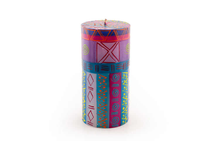 Blue Moon 3x6 pillar candle. Purple & turquoise are main colors with yellow & orange accents.