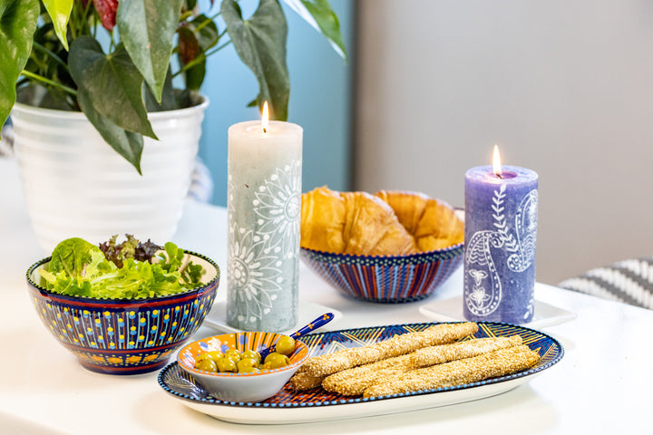 Photo of a table setting with the ceramics and Henna Pillar Candles. - great match!  The mini nut bowl in used on the ceramic serving platter to show how well this size works to hold complementary items for the food on the platter.