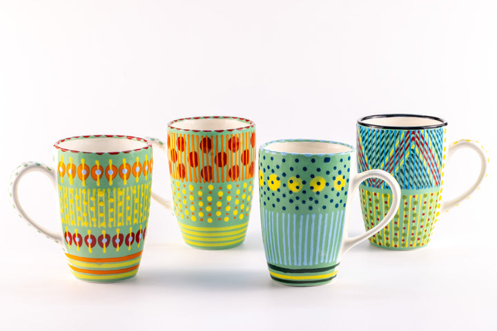 4 Very colorful coffee mugs with Jasper Green base color. Topped with dots & stripes in turquoise, orange, red, light & indigo blue.  White inside. Very happy!