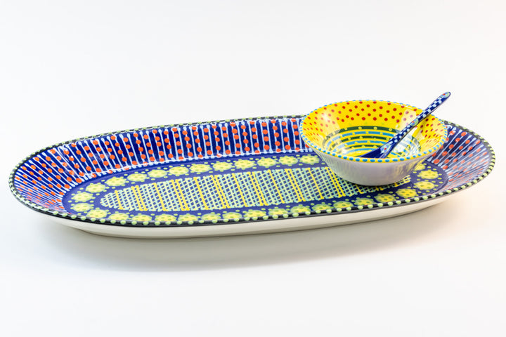 Ceramic serving platter in Indigo Blue with Yellow mini nut bowl & Indigo Blue  small spoon sitting on the platter. Perfect size for condiments and beautiful color contrasts.
