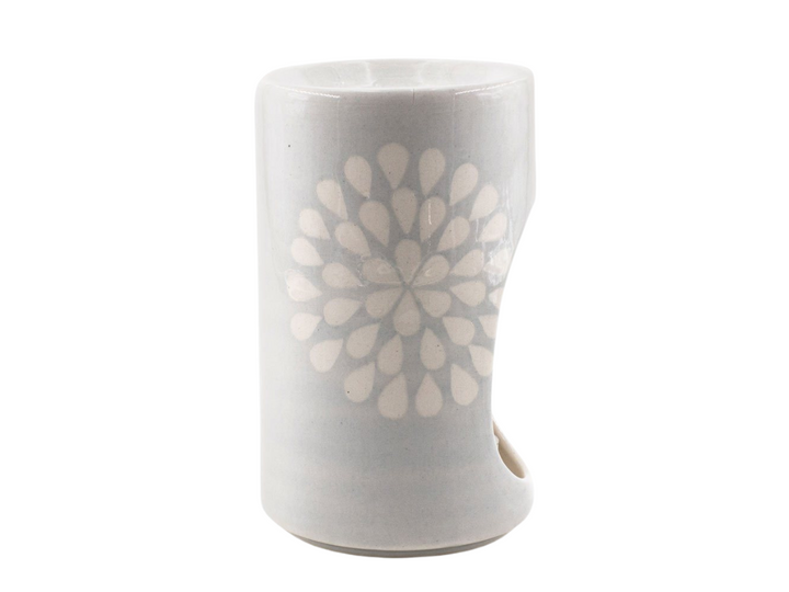 Duck egg background with white flower - -stunning! -Ceramic Burner. Tea light in bottom that glows through the opening while scent burns on top.  Design pattern painted on side. Fair Trade.