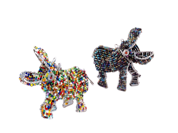 African hippos handmade from recycled silver wire and a mix of transparent and opaque beads. These hippos have their mouths wide open and look they are walking somewhere with purpose! The hippo on the left is bright multi colored with huges of red, orange, brown, lime green, dark green, teal, cobalt blue, white. The elephant on the right is tones of metallic with hues of purple, gold, teal, olive geen, navy. Fair Trade Decor. Fair Trade Gifts. Handmade Gifts. Handmade Decor. Handbeaded.