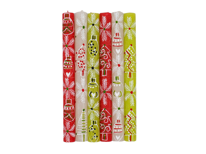 Whimsy Christmas 9" dinner taper candles photo shows the white Christmas designs painted on red, green and white tapers.  Hand painted. Fair trade home decor.