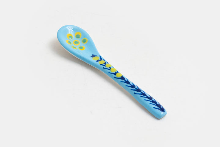 Ceramic small spoon with background color of baby blue, detail painted in red, indigo, lime green.  Great for condiments. 