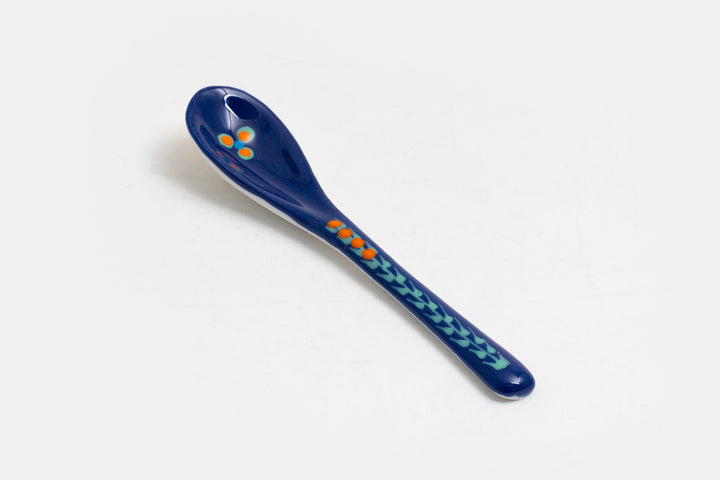 Ceramic small spoon with background color of indigo blue, detail painted in red, baby blue, lime green.  Great for condiments. 