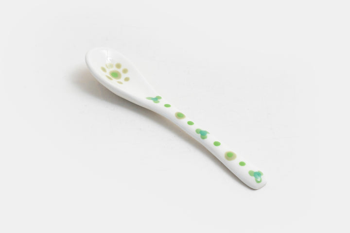 Ceramic small spoon with background color of white, detail painted in red, indigo, orange, & baby blue.  Great for condiments. 