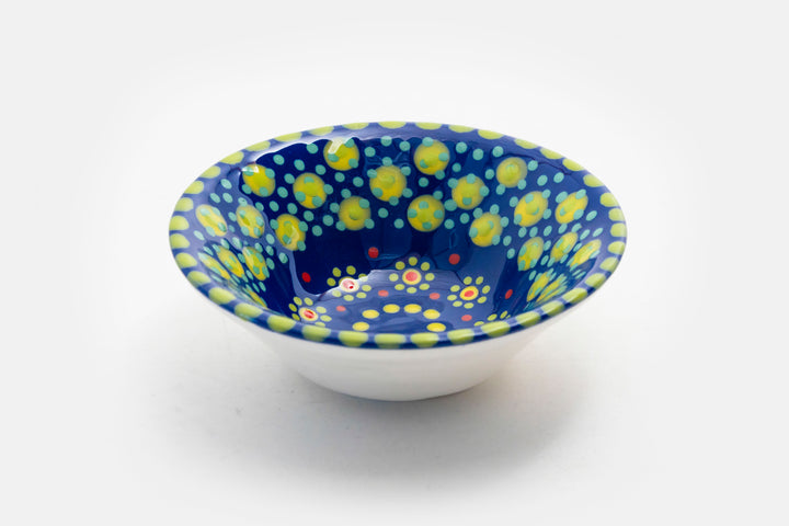 'Nut' size ceramic bowl with indigo blue base color. Dots & Stripes and flowers painted on top in orange, jasper green, turquoise blue & yellow.