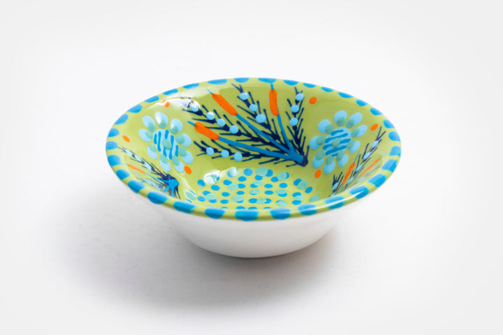 'Nut' size ceramic bowl with lime green base color. Dots & Stripes and flowers painted on top in orange, indigo, turquoise blue & yellow.