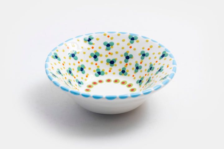 'Nut' size ceramic bowl with while base color. Dots & Stripes and flowers painted on top in orange, jasper green, turquoise blue & yellow.