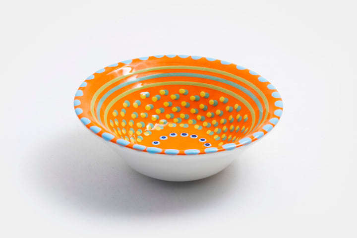 'Nut' size ceramic bowl with orange base color. Dots & Stripes and flowers painted on top in lime green, jasper green, turquoise blue & yellow.