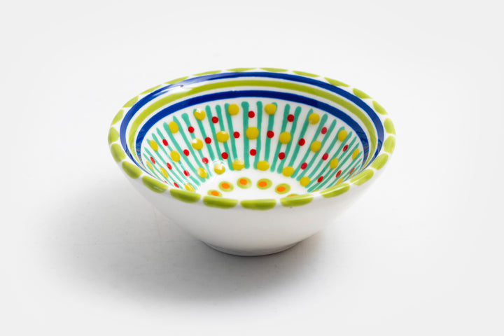 Tiny ceramic bowl, white background with mixed patterns of dots & stripes in different sizes and colors. Microwave & Dishwasher safe.