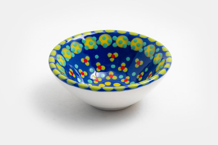 Tiny ceramic bowl, indigo blue background with mixed patterns of dots & stripes in different sizes and colors.  Microwave & Dishwasher safe.