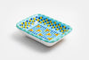 Ceramic rectangle shape Tiny Dish with Baby Blue base color. Dots & Stripes and flowers  painted on top in yellow, red, indigo, lime green and orange.