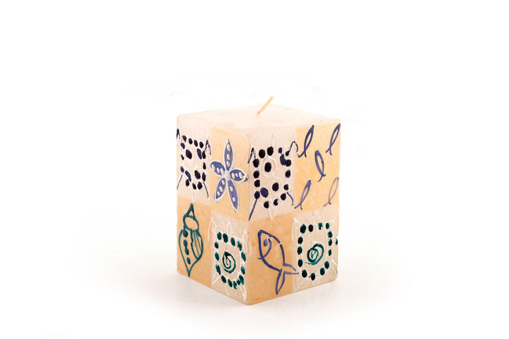 Arniston 2x2x3 cube.  Star fish, fish and turtles are painted on the cube in blue, cream and sea green.  Base candle is white.