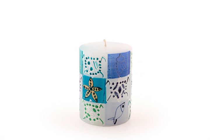 Arinton 3 x 4 pillar.  Fish, turtle, and star fish in turquoise, blue and sea green on white candle.