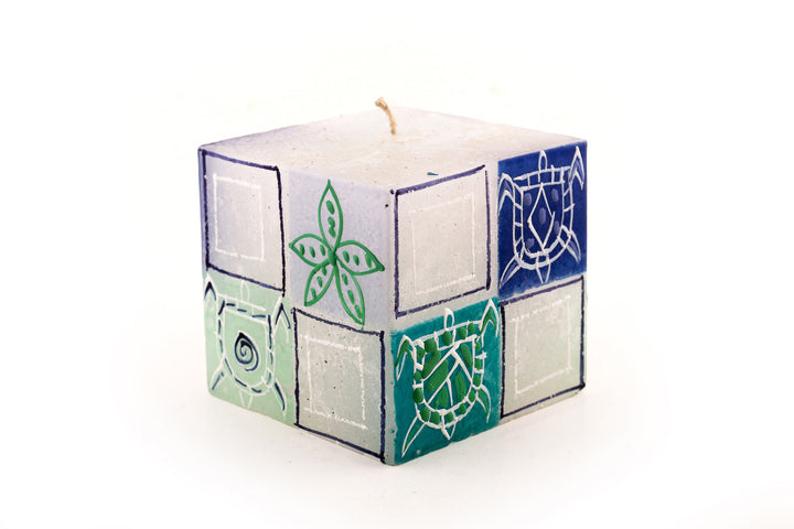 Arniston 3x3x3 cube with star fish and turtles painted on the sides in blue, sea green and turquoise.  Base candle is white.