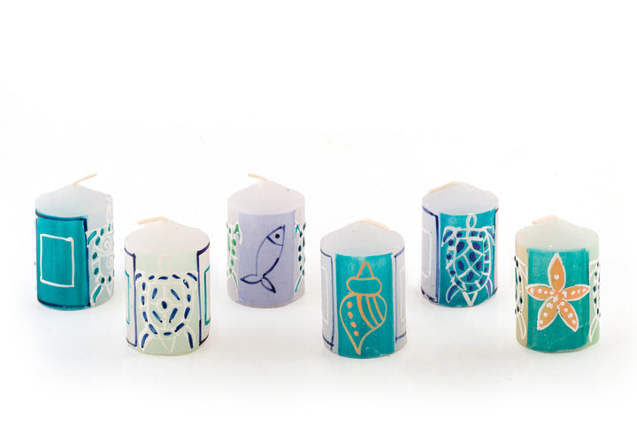 6 Arniston votives in various designs with turtles, star fish, fish and sea shells painted on the side in turquoise, blue, sea green and cream.  Base candle is white.  6 votives are sold in gift pack.