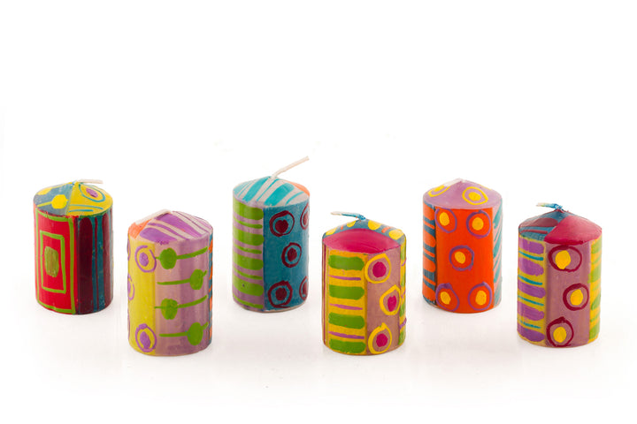 Six Carousel  2" votive candles in various designs. Dots, stripes and circles in pinks, purple, yellow, red, greens and turquoise!  The 6 votives come in a gift pack.