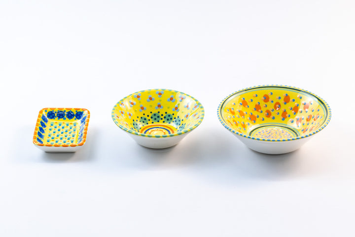 3 ceramic bowls with yellow base color to compare the size of the (from left) Tiny rectangle bowl, Mini-Nut Bowl, and Nut Bowl. Collect all three!