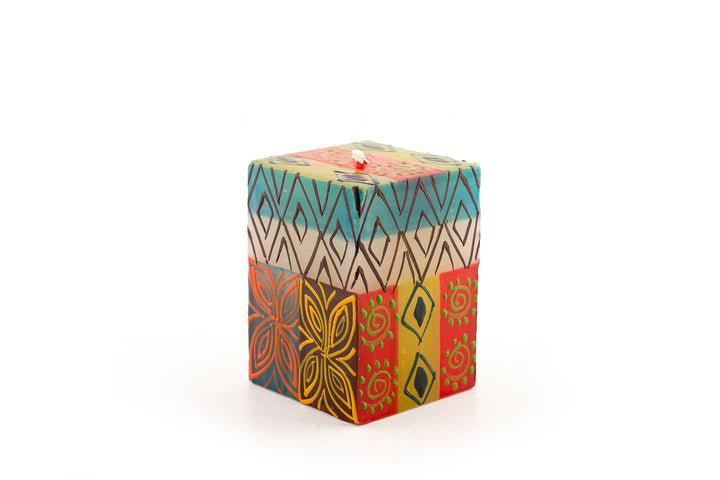 Desert Rose 2x2x3 cube candle. Beautiful colors of the African desert; golden yellow, turquoise blue, browns, orange painted in blocks of color with abstract patterns on top.