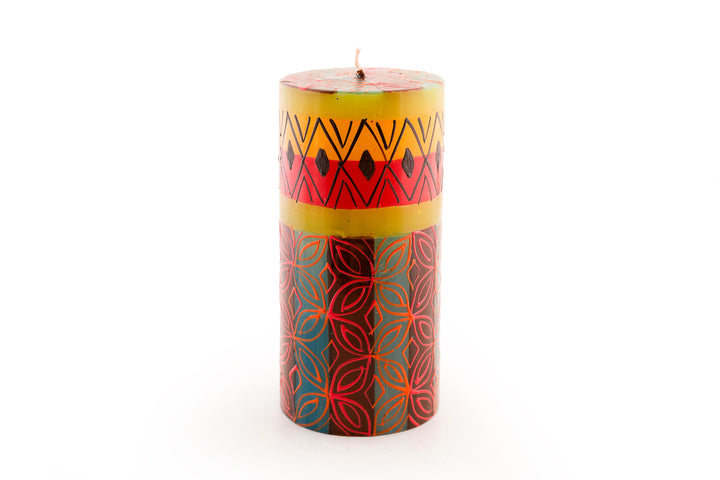 Desert Rose 3x6 pillar candle. Beautiful colors of the African desert; golden yellow, turquoise blue, browns, orange painted in blocks of color with abstract patterns on top.