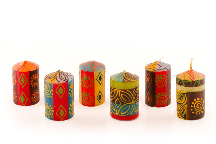 6 Desert Rose 2" votive candles. The votives come in a 6 pack. Beautiful colors of the African desert; golden yellow, turquoise blue, browns, orange painted in blocks of color with abstract patterns on top.