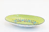 Lime green oval serving bowl with dots, stripes and small flowers painted in baby blue, green and yellow. 15" x 8". Perfect to top off any table!