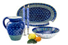 Beautiful Indigo blue water jug, large oval serving bowl, and large round serving bowl  along side a pair of Henna white on blue taper pairs. Stunning collection!