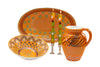 Wonderful orange water jug, large oval serving bowl, and large round serving bowl  with floral print in lime, baby blue and indigo. Along side a pair of Summer tapers.  Stunning collection