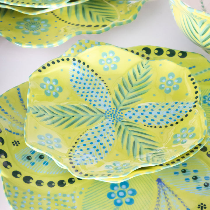 Tulip cocktail plate on dinner plate with lime green background, baby blue and green floral design.  This is a sample of the other colors available for the ceramic dinner set.