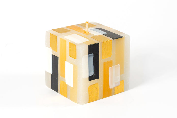 Klimt 3" cube candle. Creamy white base color candles with touches of black, gold and white.