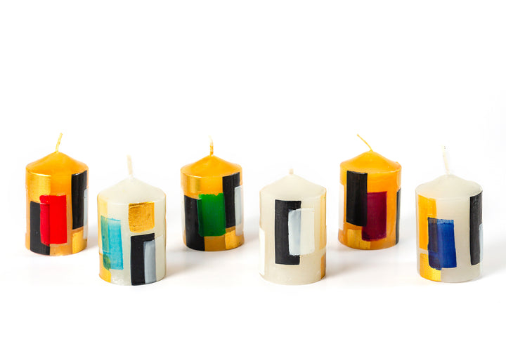 Klimt 2" votive candles. 3 with Creamy gold base color and 3 with creamy white base color. Each candle has touches of black, gold along with hints of red, green, blue, turquoise, white & purple.