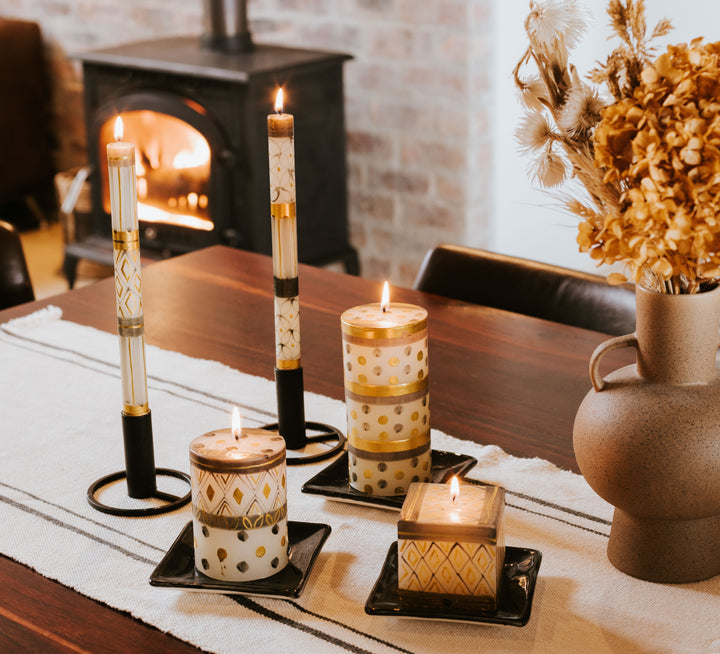 Table setting with fireplace in background.  Celebration tapers, pillars and cube lit on the table.  This collection is truly beautiful when burning!