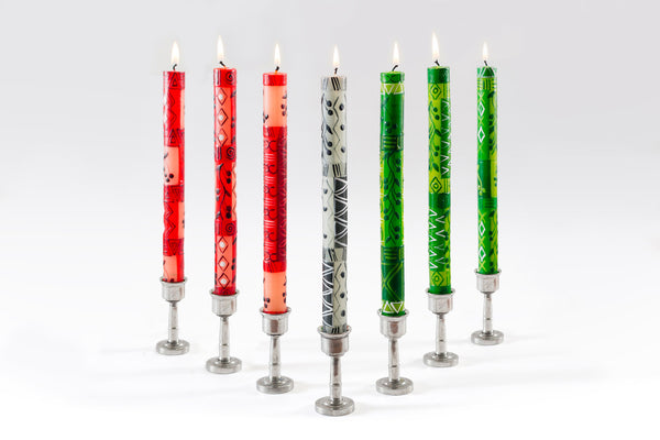 Kwanzaa Candle Taper Collection. 7 tapers total, 3 red, 1 black and white, and 3 green. Whimsical, painted designs with stripes, triangles, & vines.