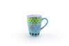Very colorful coffee mug with baby blue base color.  Topped with dots & stripes in yellow, orange, green, & indigo blue.  White inside. Very fun!