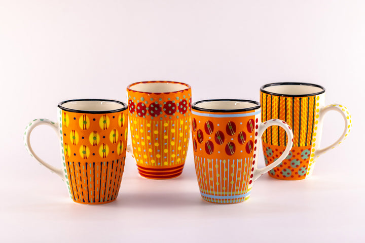 4 Very colorful coffee mugs with Orange base color. Topped with dots & stripes in green, light blue, yellow, and red.  Bright & fun!