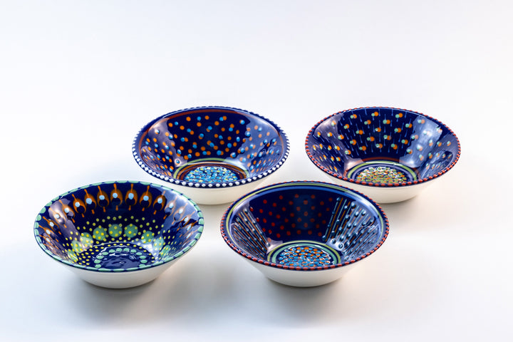 4 'nut' size ceramic bowls with indigo blue base color. Dots & Stripes painted on top in orange, jasper green, turquoise blue & yellow.