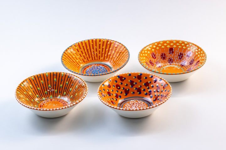 4 'nut' size ceramic bowls with Orange base color. Dots & Stripes painted on top in red, jasper green, yellow & turquoise blue.