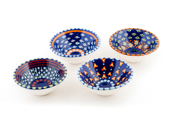 Tiny ceramic bowl, indigo blue background with mixed patterns of dots & stripes in different sizes and colors. 