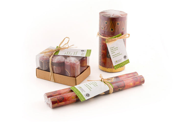Photo of the candle packaging.  Votives are in a 6-pack box tied with story card.  All other shapes are  wrapped in sustainable cello with a story card.  Tapers are a matched pair, wrapped, and tied with a story card.