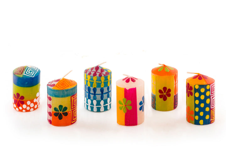 6/ 2" Summer votive candles. Flowers, dots and petal chain designs in summer colors. The 6 votives come in a gift pack.