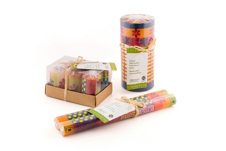 Summer votive 6-pack gift box.  Summer 3x6 pillar wrapped in sustainable cello with a story card.  All candle shapes are packaged in this manner.  Summer matched taper pair, wrapped and tied with a story card.