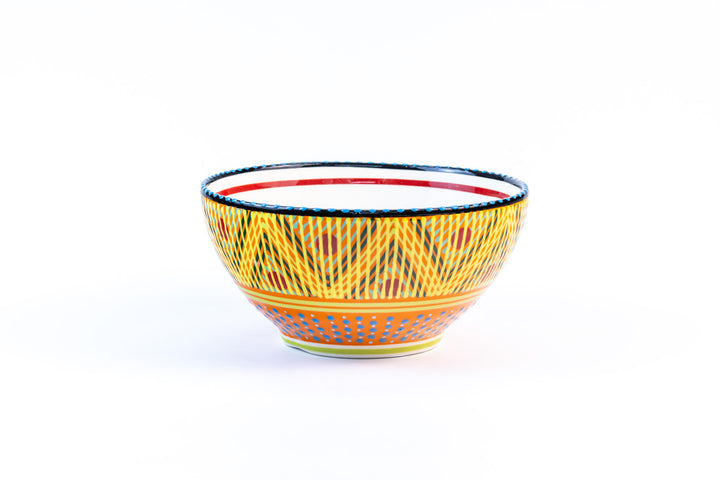 Ceramic serving bowl with base color of yellow. Dots & Stripes painted on top in fun colors of jasper green, turquoise, orange & red. White inside the bowl.
