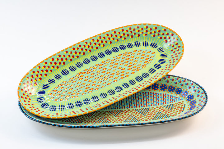 Two ceramic serving platters with Jasper Green base color.  Dots & Stripes painted on top in red, yellow, indigo blue, and orange. Just beautiful!