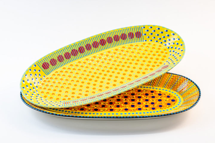 Two ceramic serving platters with Yellow base color. Dots & Stripes painted on top in red, indigo blue, turquoise, Jasper Green, and orange. Stunning!