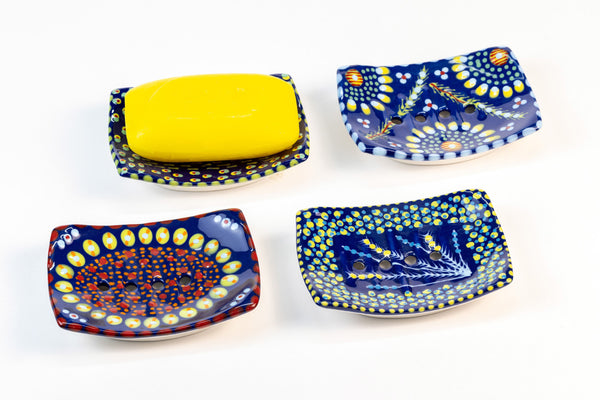 Ceramic square soap dish with base color of Indigo Blue.  Flowery design with dots painted on top in yellow, turquoise, red and touches of orange.  Drain holes in dish!