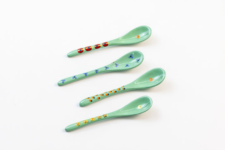 Small ceramic spoons with base color of Jasper Green. Tiny dots & flowers painted on top in yellow, orange, light blue, and red. Lovely!