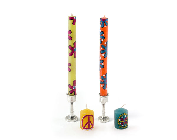 Two single Hippie tapers in pewter candle holders with two votives in front.  Each in a different fun Hippie design!  green & orange tapers with flowers, yellow votive with peace sign and turquoise with abstract design.