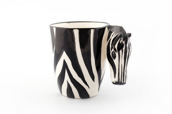 Ceramic Zebra coffee mug. White mug painted in zebra print with a zebra head for the handle! White inside. Very cute!